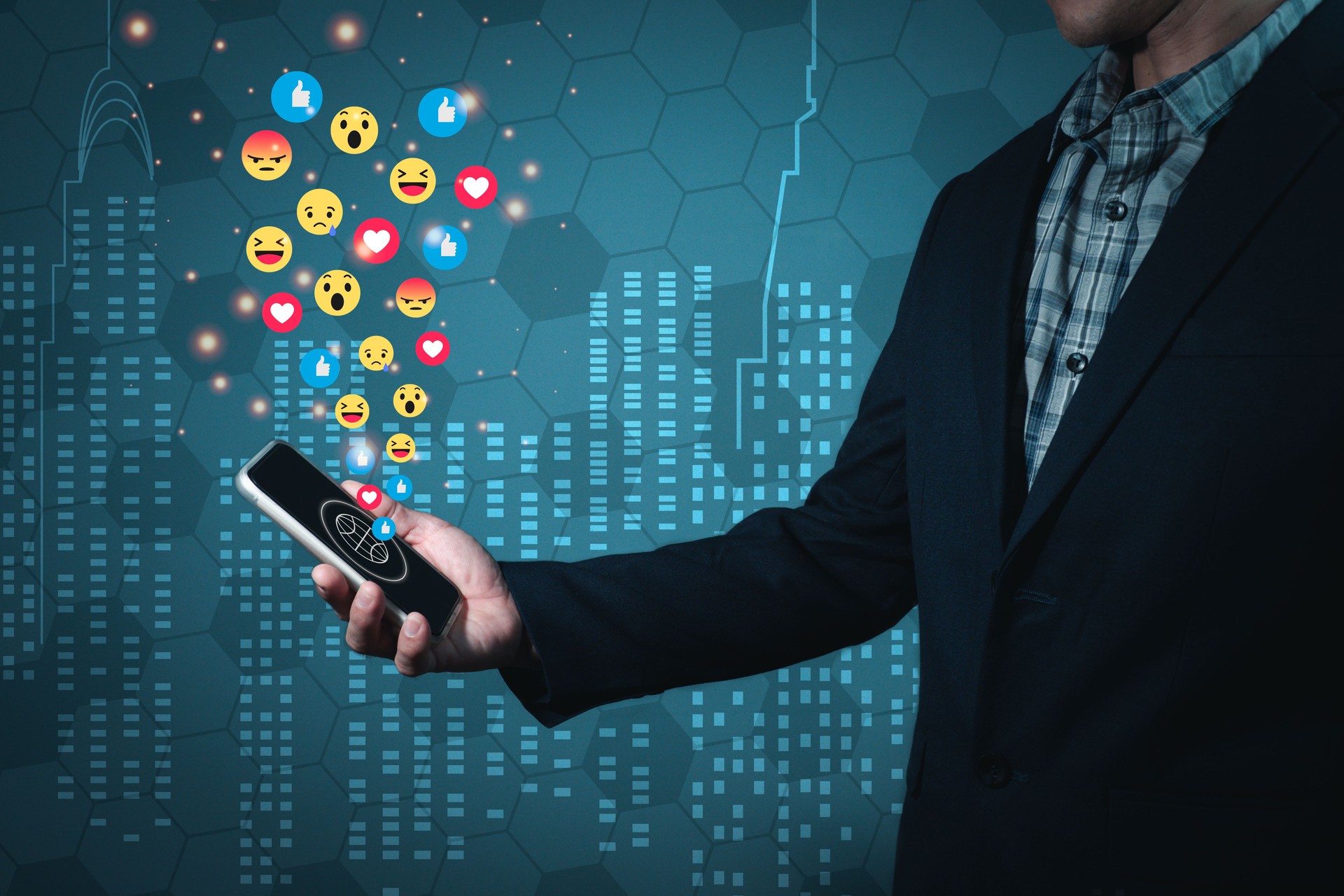 A man wearing a suit holds a mobile phone forwarded in a manner that reads a message on the screen. There are emojis emitting from the screen. Abstract background
